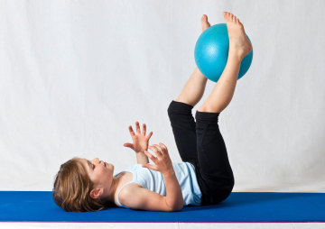 girl-in-white-shirt-and-black-pants-lying-on-blue-exercise-3992594